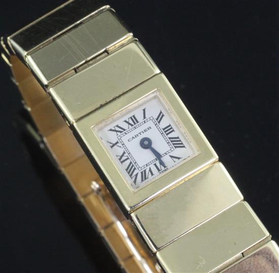 A ladys 18ct gold Cartier quartz bracelet watch, with Cartier pouch.